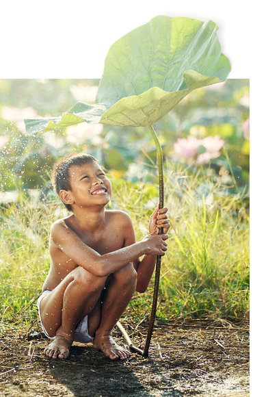 a child playing outside while it is raining