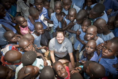 white woman meets a group of friendly children